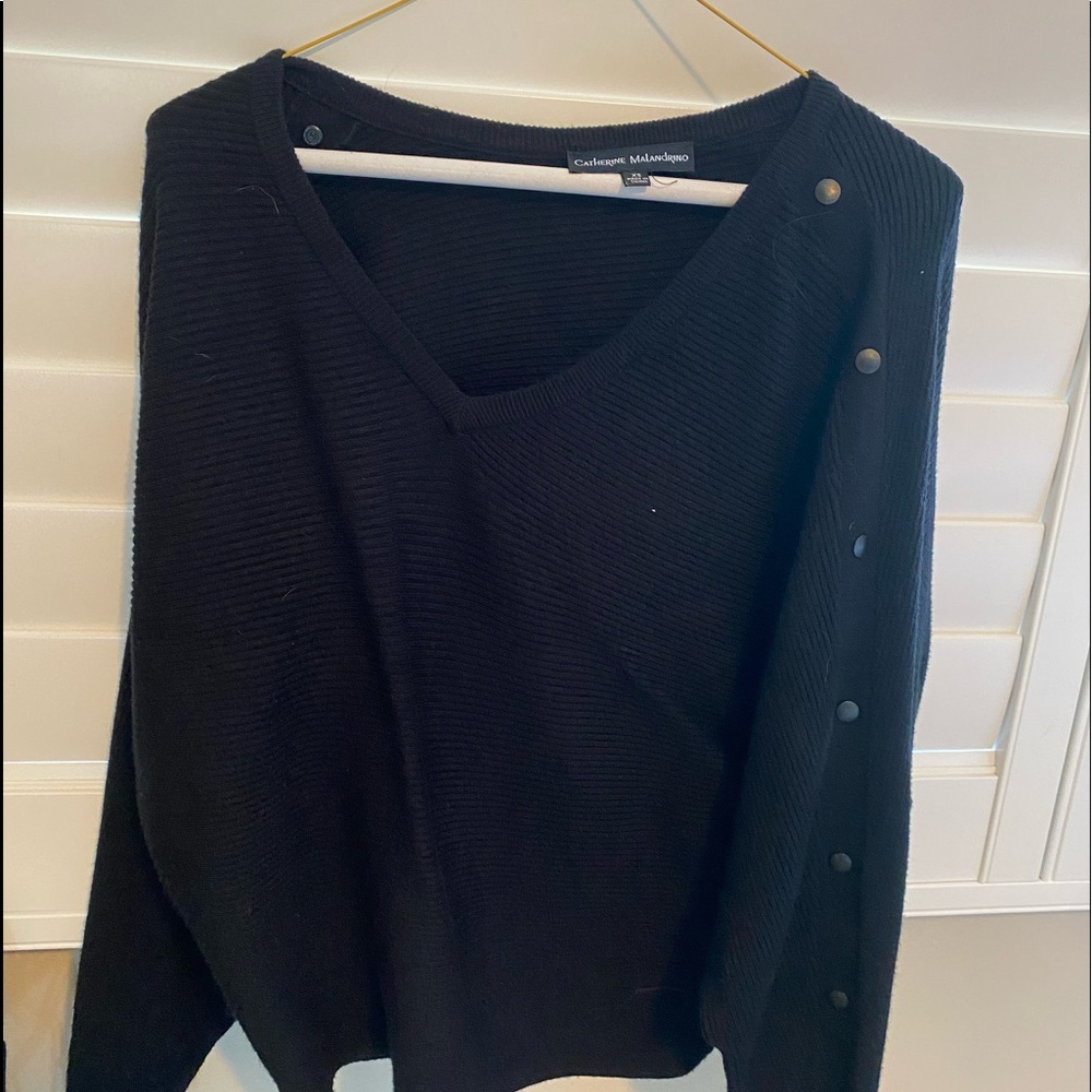 long sleeve black top with buttons down sides of sleeves
